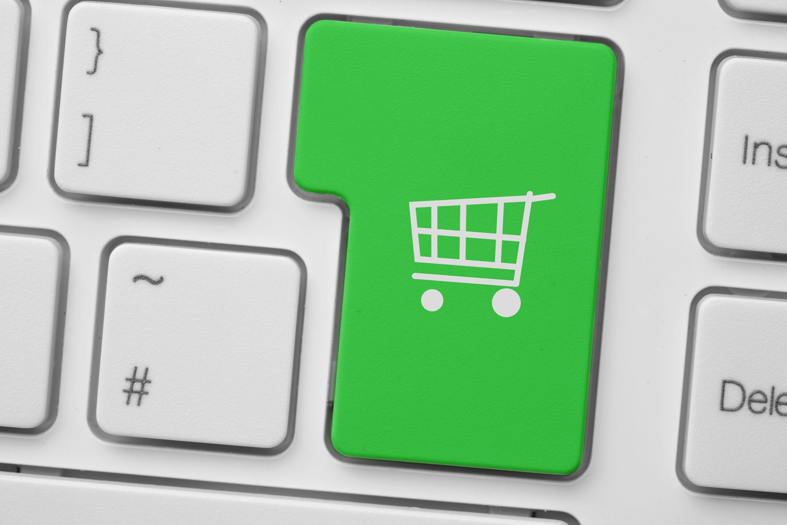 green keyboard button with a white shopping cart